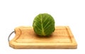 Head of cabbage on a wooden ÃÂutting board on a light background.